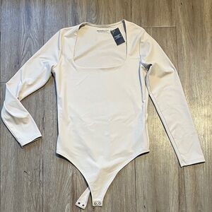 Abercrombie & Fitch Long Sleeve Scoop Neck Bodysuit in Light Beige